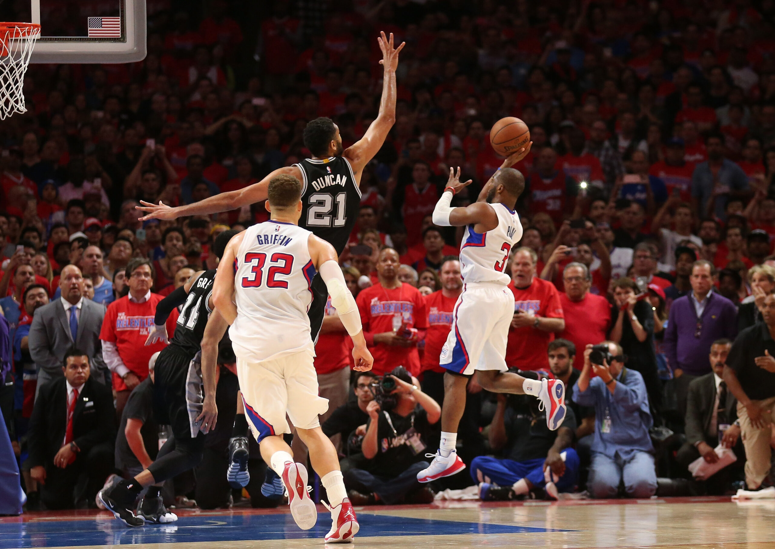 LOS ANGELES, CA - MAY 02:  Chris Paul #3 of the Los Angeles Clippers puts up the game winning shot over Tim Duncan #21 of the San Antonio Spurs with one second remaining in Game Seven of the Western Conference quarterfinals the 2015 NBA Playoffs as Clipper Blake Griffin stands by at Staples Center on May 2, 2015 in Los Angeles, California.  The Clippers won 111-109 to win the series four games to three.  NOTE TO USER: User expressly acknowledges and agrees that, by downloading and or using this photograph, User is consenting to the terms and conditions of the Getty Images License Agreement.  (Photo by Stephen Dunn/Getty Images)